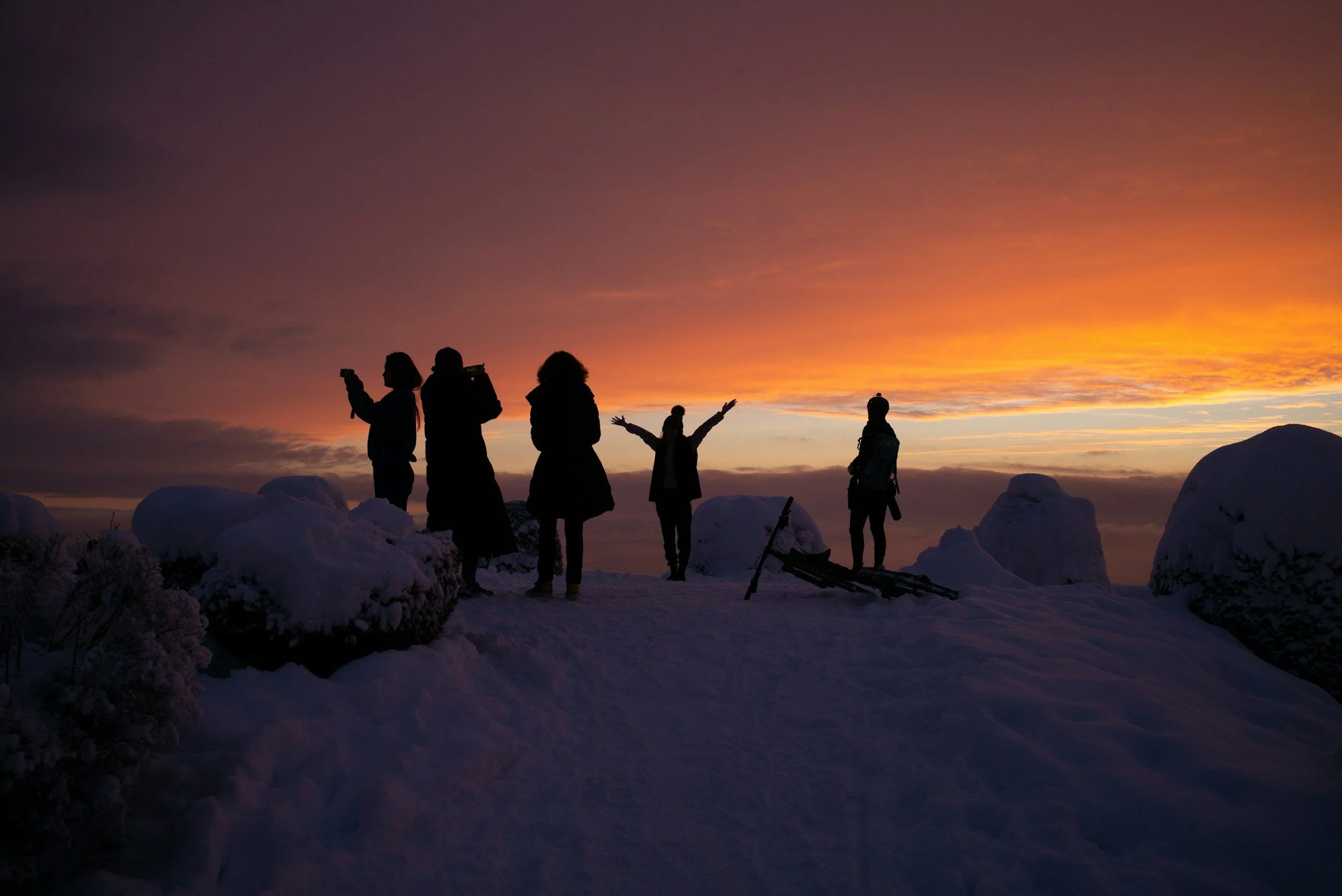 People standing together at sunset