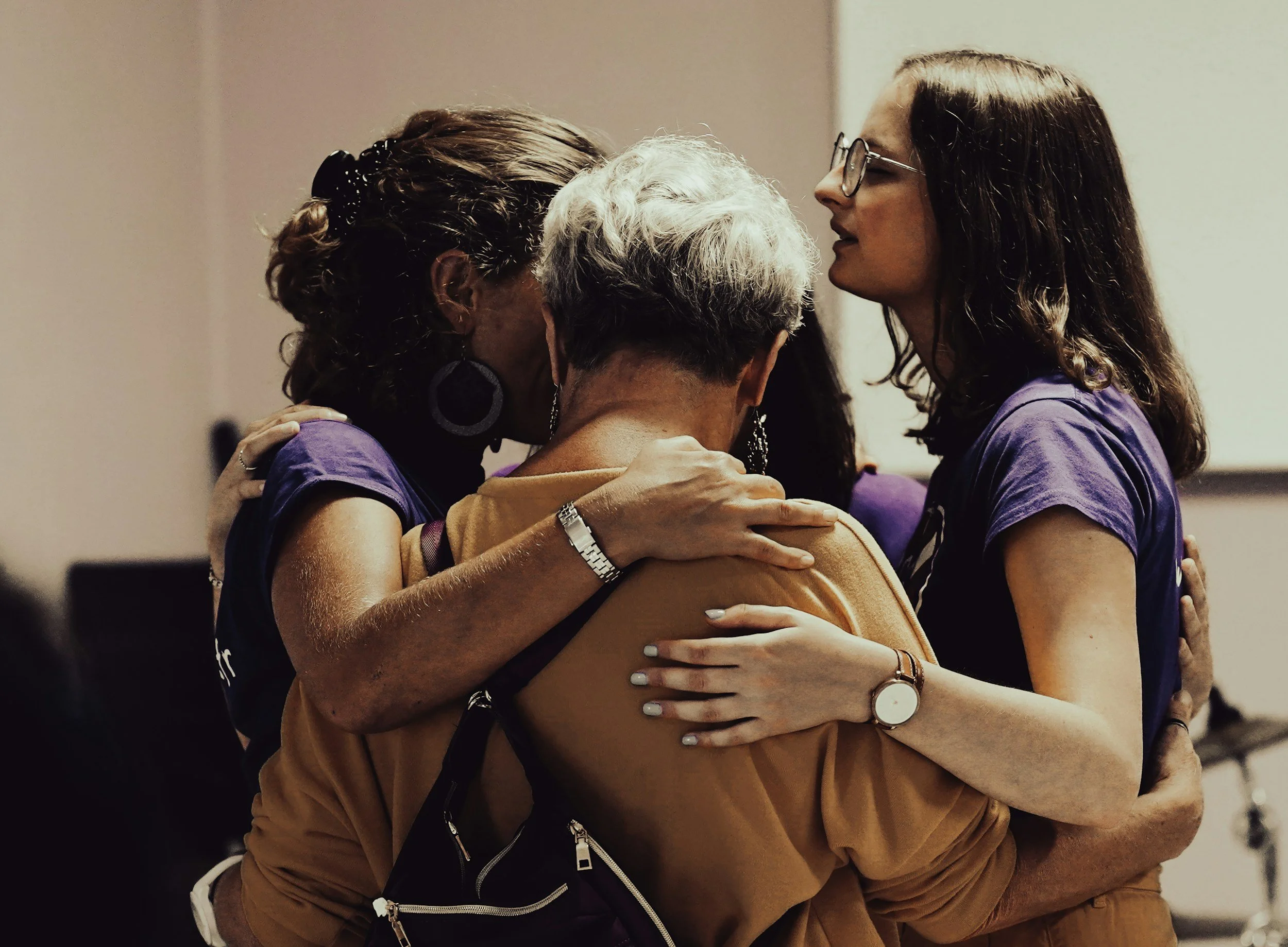 People embracing in support
